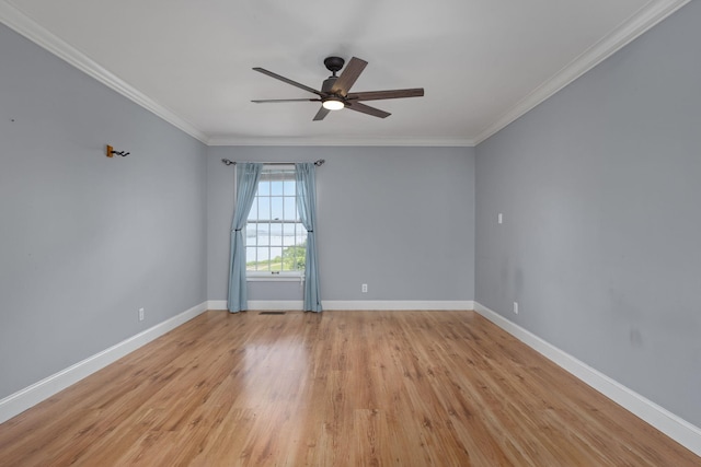  - empty room with a ceiling fan, ornamental molding, baseboards, and light wood-type flooring