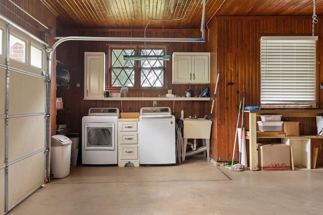  - garage featuring washer and dryer, wooden ceiling, wood walls, and a sink