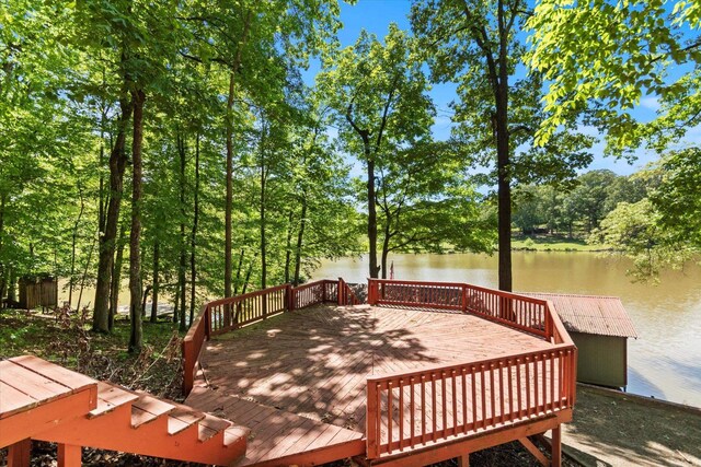  - deck with a water view and view of scattered trees