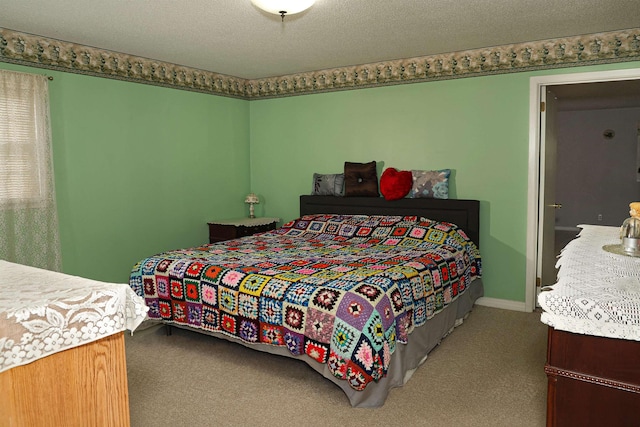 bedroom featuring carpet and a textured ceiling