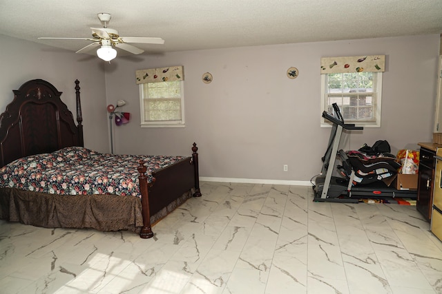 bedroom with a textured ceiling and ceiling fan