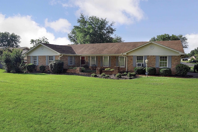 ranch-style house featuring cooling unit and a front yard