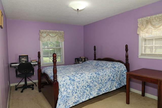 bedroom with light carpet and a textured ceiling