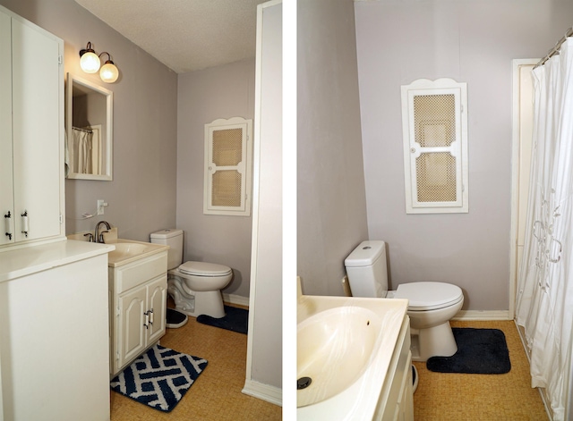 bathroom with a textured ceiling, vanity, and toilet