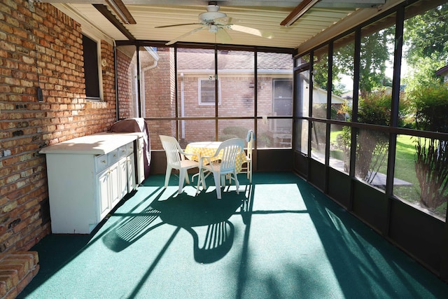 sunroom / solarium featuring ceiling fan