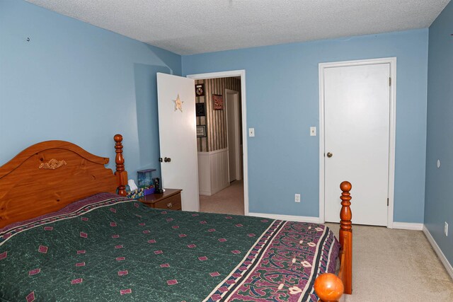 carpeted bedroom featuring a textured ceiling