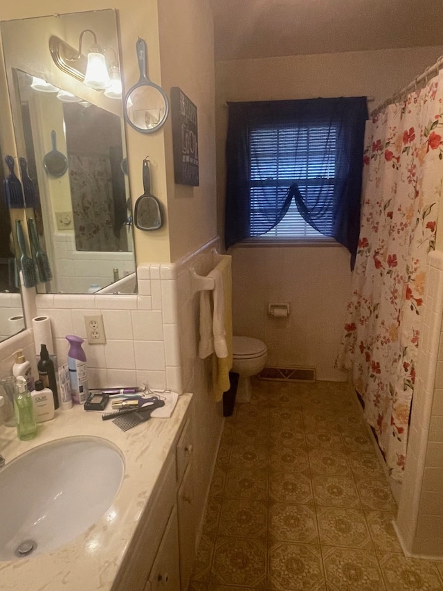 bathroom featuring tasteful backsplash, vanity, toilet, tile patterned floors, and a shower with shower curtain