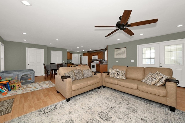 living room with hardwood / wood-style flooring and ceiling fan