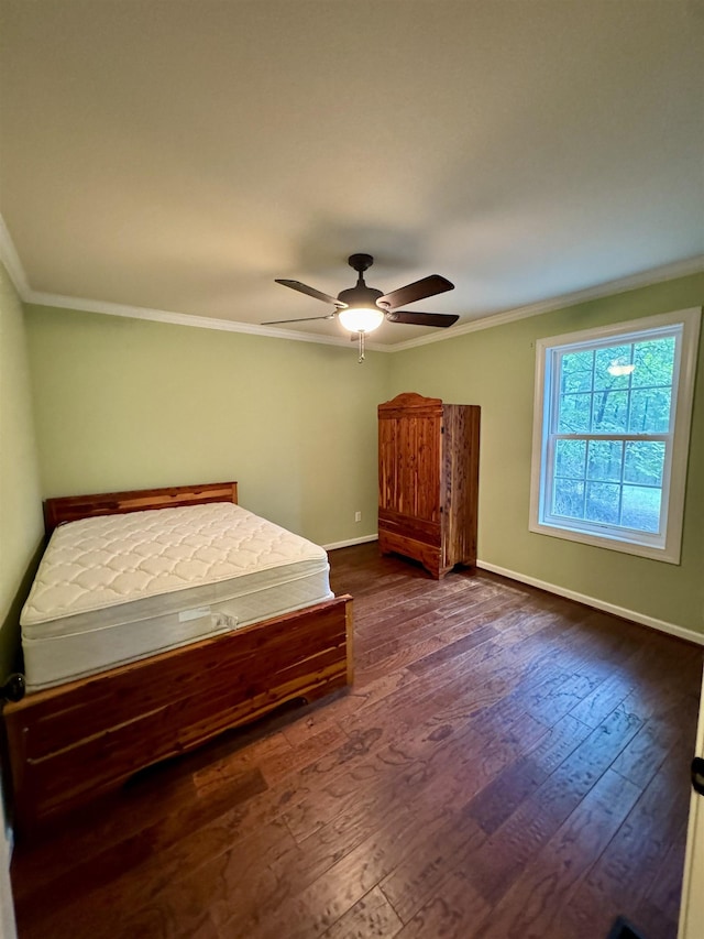 unfurnished bedroom featuring ceiling fan, dark wood-type flooring, and ornamental molding