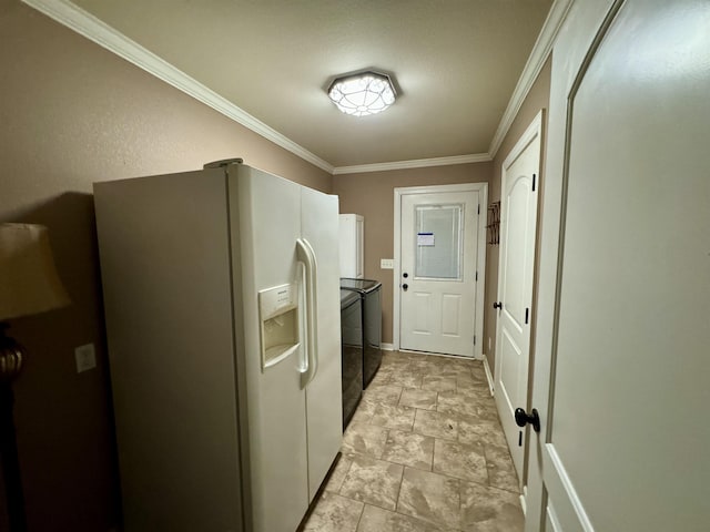 laundry room featuring washing machine and dryer and crown molding