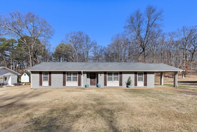 single story home with a front yard and a carport