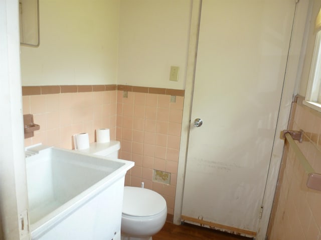  - bathroom with tile walls, wainscoting, and vanity
