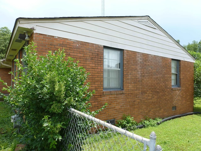  - view of home's exterior featuring brick siding and crawl space
