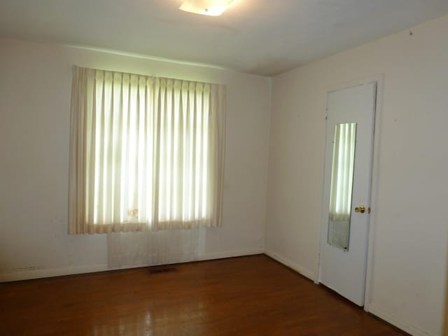  - spare room with wood finished floors and baseboards