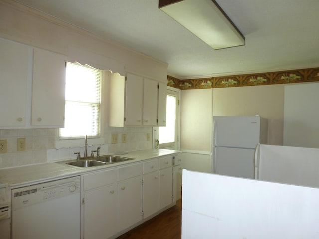  - kitchen with white appliances, white cabinetry, tasteful backsplash, light countertops, and crown molding