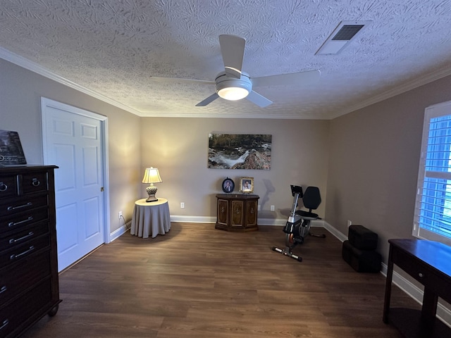 living area featuring wood finished floors, a textured ceiling, visible vents, a ceiling fan, and baseboards
