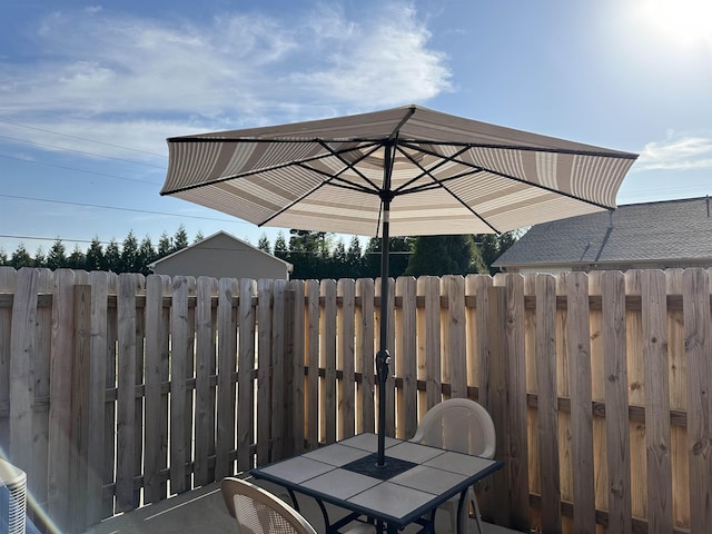 view of patio featuring fence and outdoor dining space