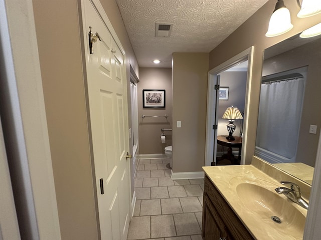 full bath featuring toilet, baseboards, visible vents, tile patterned flooring, and vanity