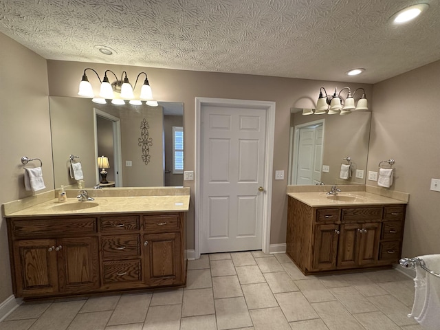 full bathroom featuring a sink, two vanities, and tile patterned floors