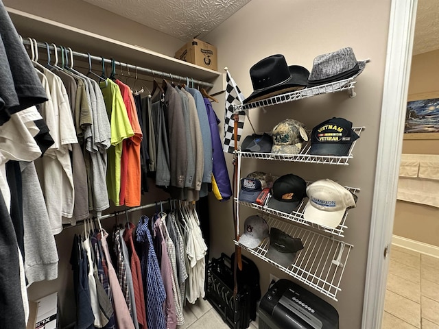 spacious closet with tile patterned floors