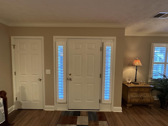 foyer entrance featuring visible vents, dark wood-style flooring, and baseboards