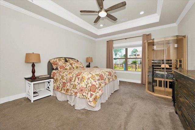 carpeted bedroom featuring a raised ceiling, ceiling fan, and ornamental molding