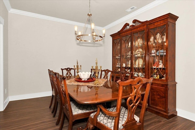 dining room with dark hardwood / wood-style floors, crown molding, and a notable chandelier