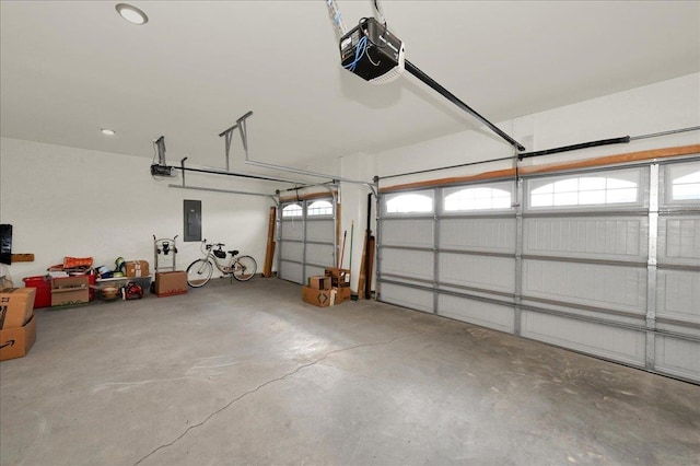 garage featuring electric panel and a garage door opener