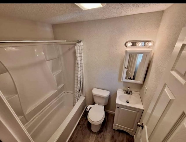 full bathroom with shower / bath combination with curtain, vanity, a textured ceiling, wood-type flooring, and toilet