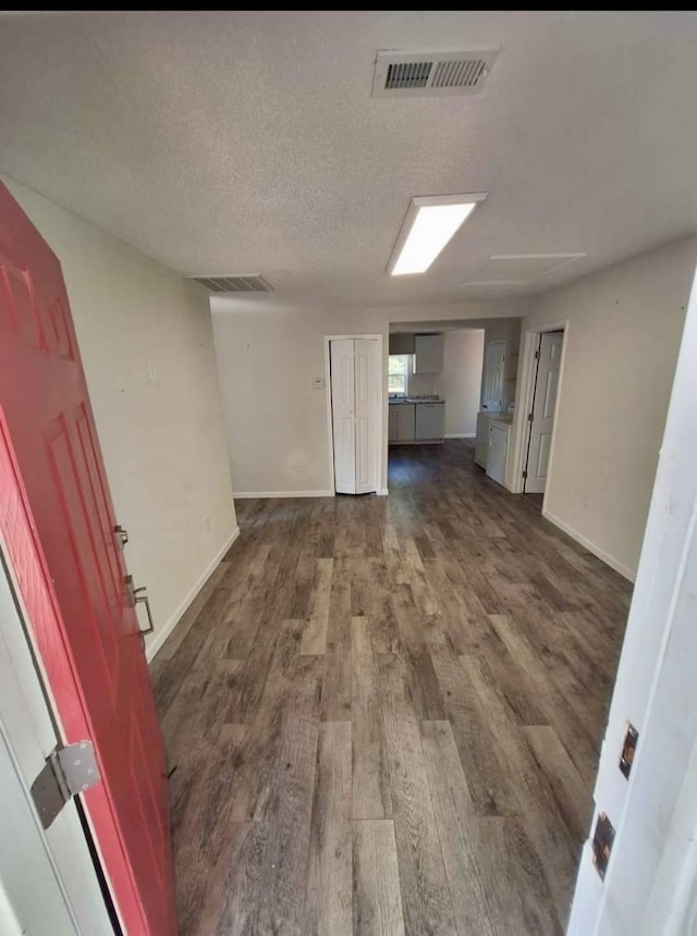 interior space with dark hardwood / wood-style floors and a textured ceiling