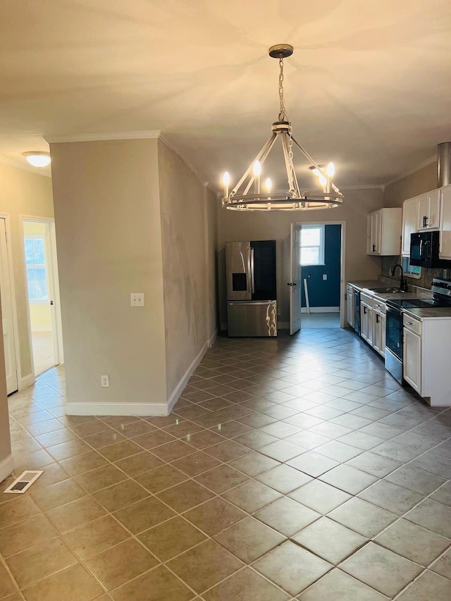  - kitchen featuring a notable chandelier, range with electric cooktop, crown molding, and stainless steel fridge