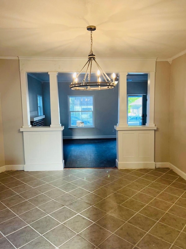  - unfurnished dining area with dark tile patterned floors, crown molding, baseboards, and a notable chandelier