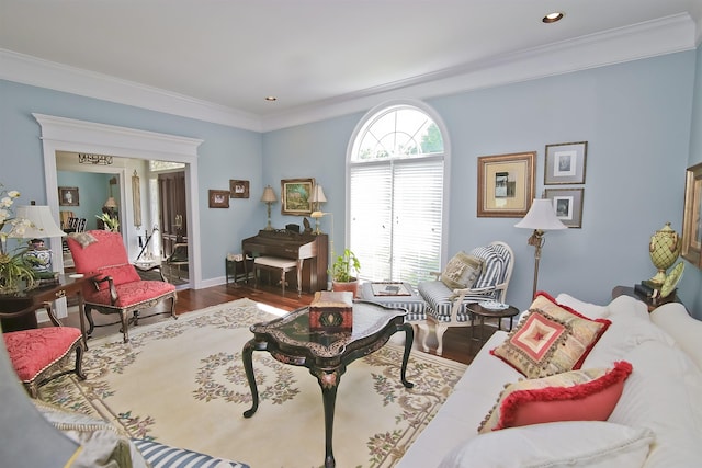 living area with ornamental molding and wood finished floors