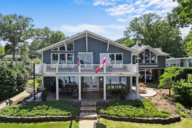 view of front facade with an outdoor hangout area, a patio, and french doors