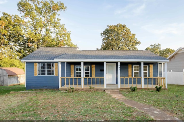 ranch-style house with a porch and a front yard