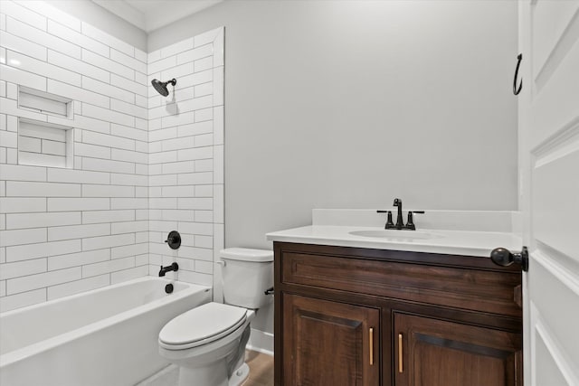 full bathroom with tiled shower / bath, vanity, and toilet