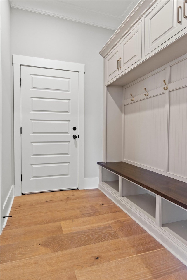 mudroom with crown molding and light hardwood / wood-style floors