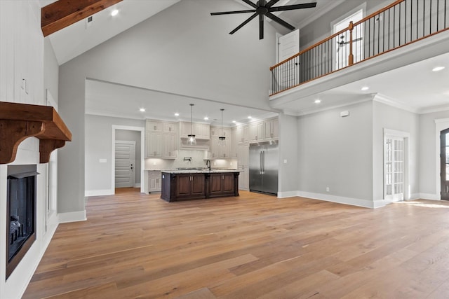 unfurnished living room with high vaulted ceiling, ornamental molding, light hardwood / wood-style floors, and ceiling fan