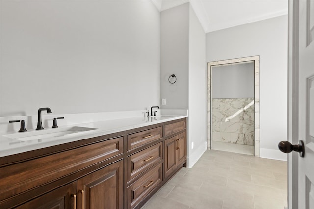 bathroom featuring ornamental molding, vanity, and a tile shower