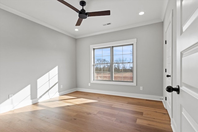 unfurnished room featuring hardwood / wood-style floors, crown molding, and ceiling fan