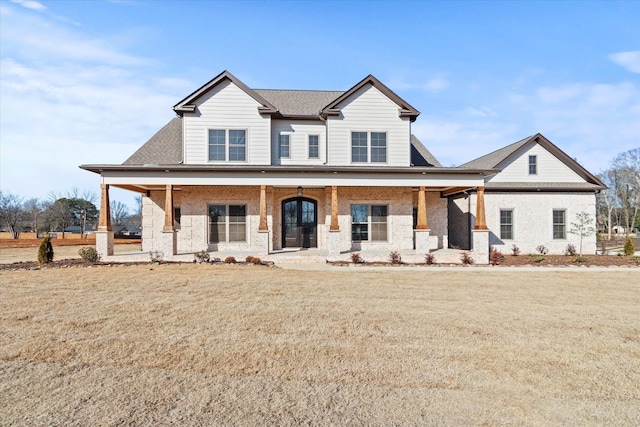 view of front facade with a front lawn and covered porch