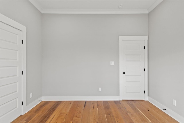 unfurnished room with wood-type flooring and ornamental molding