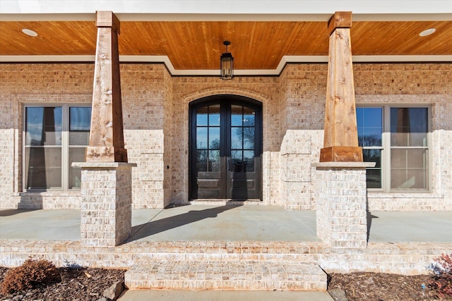 entrance to property featuring french doors and covered porch