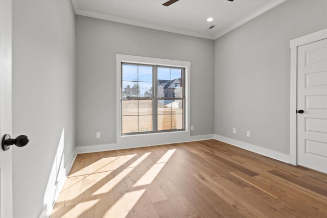 spare room featuring ornamental molding, ceiling fan, and light hardwood / wood-style floors