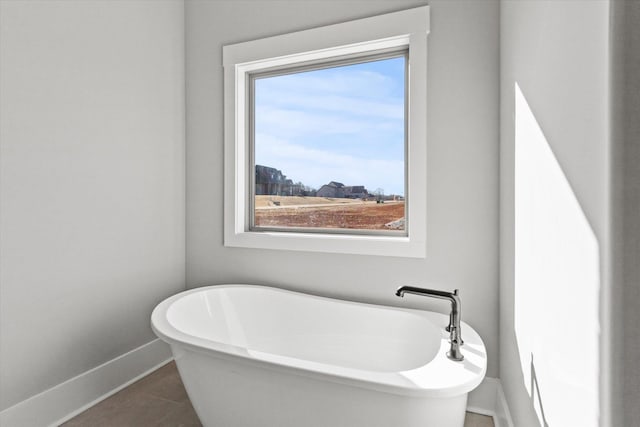 bathroom featuring a washtub and tile patterned flooring