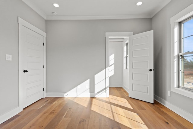 interior space with ornamental molding and light wood-type flooring