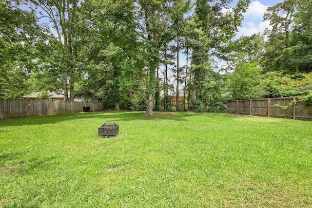  - fenced backyard with an outdoor fire pit