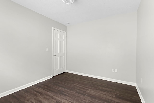  - empty room with dark wood-type flooring