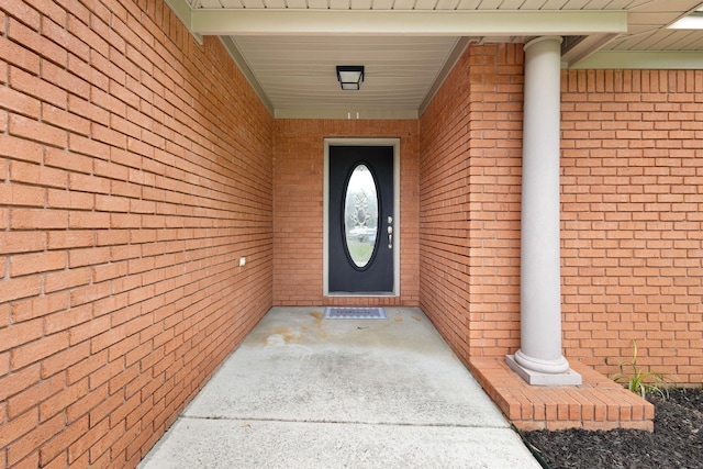  - doorway to property with brick siding