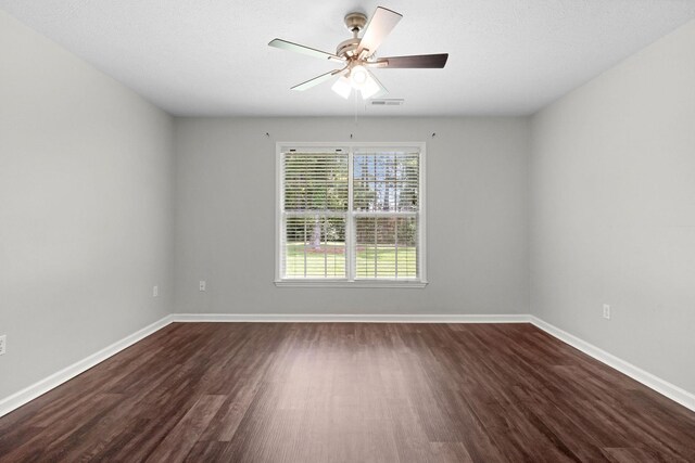  - empty room with dark wood finished floors and ceiling fan